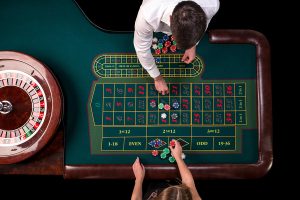 man croupier woman playing in casino